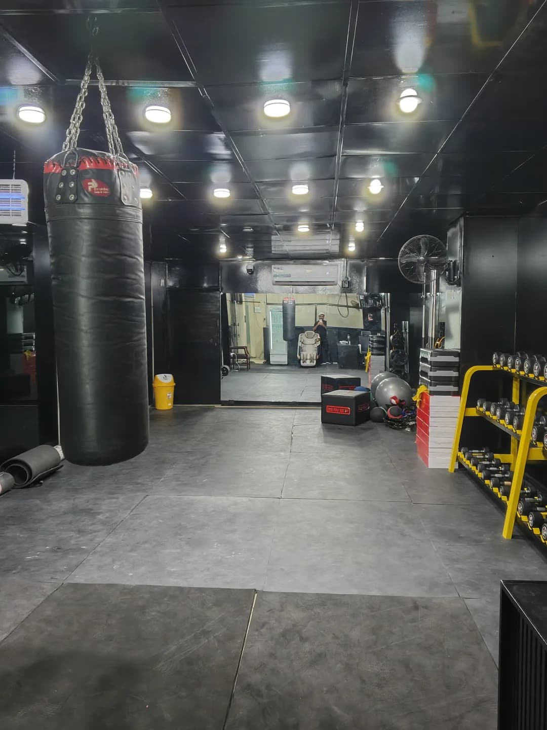 Boxing bag beside the mirrored training floor