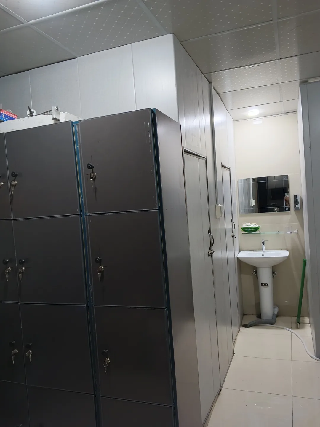 Vertical view of lockers and washbasin