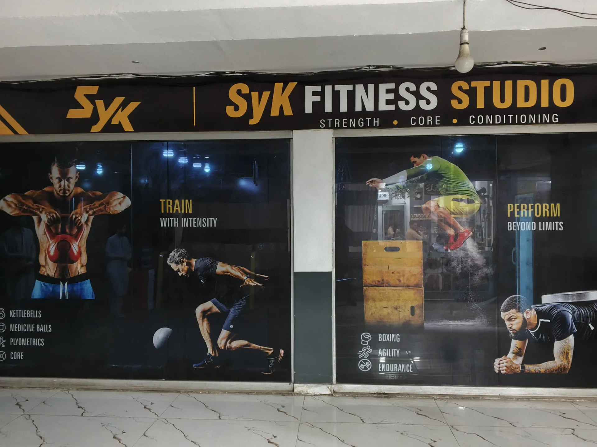 SyK Fitness Studio entrance with branded window graphics