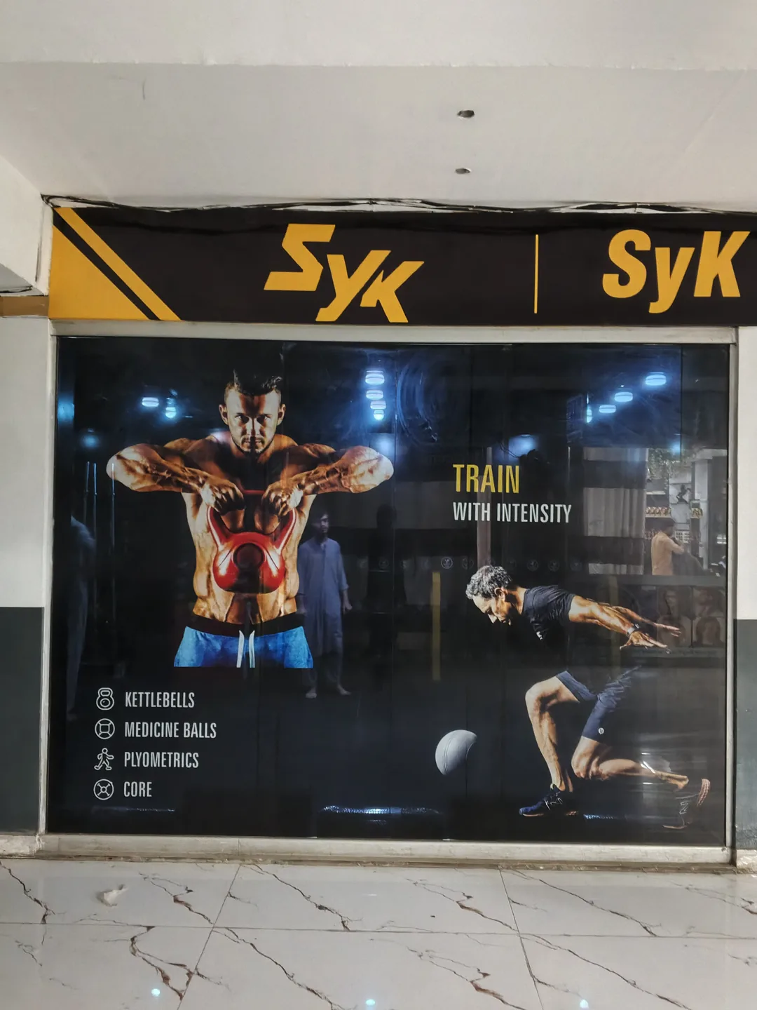 SyK logo above the left storefront window